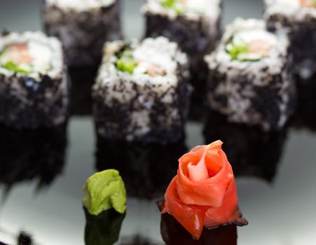 Japanese cuisine: sushi roll on black plate