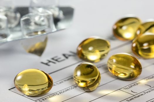 Cod liver oil capsules on health insurance form
