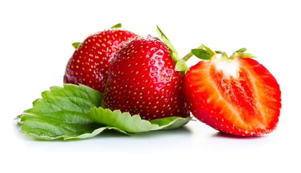 Strawberries with green leaves isolated on white background