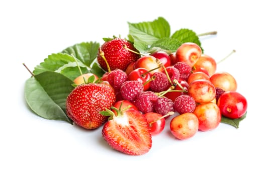 Berries assortment with green leaves isolated on white background