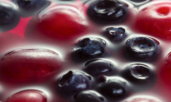 Close up view of cherries and blueberries in jelly