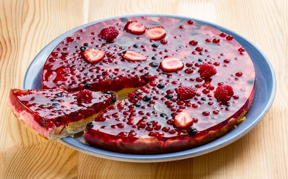 Berries cake on wooden table background