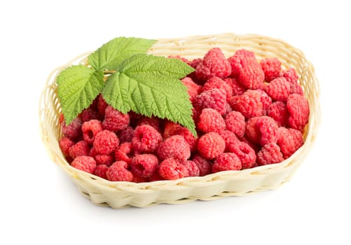 Ripe fresh raspberries with green leaf in basket isolated on white background