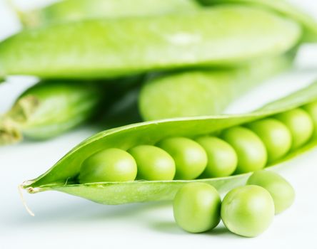 Green pea pod isolated on white