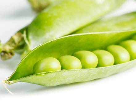 Green pea pod on white background