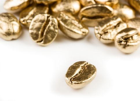 Gold coffee beans isolated on white background