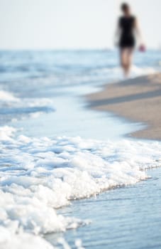 Beach with walking woman