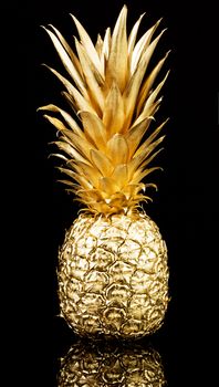 Gold pineapple on black background