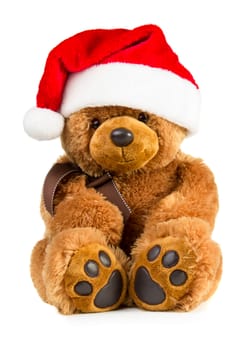 Toy teddy bear wearing a santa hat isolated on white background