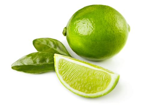 Whole and sliced limes with leaves isolated on white