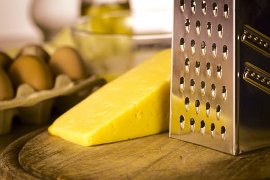 Grater, cheese on cutting board
