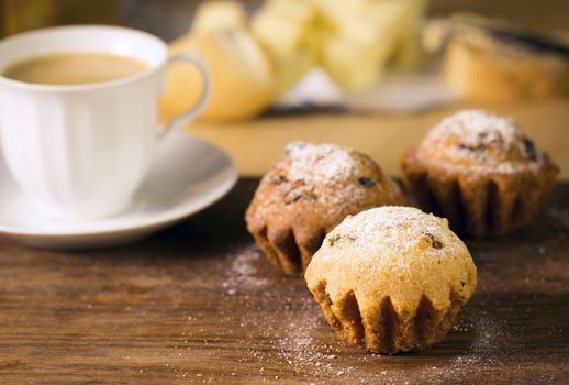 Breakfast: muffins and coffee on wooden table