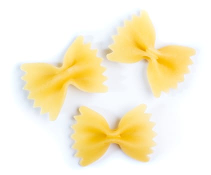 Three bow tie of farfalle pasta on white background