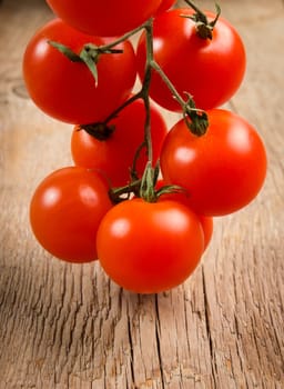 Cherry tomatoes on a wooden surface with natural light