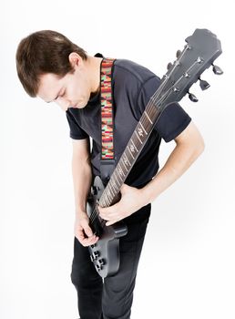 Young man with a black electric guitar