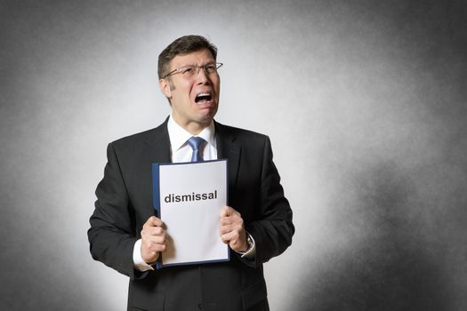 Crying business man with german dismissal