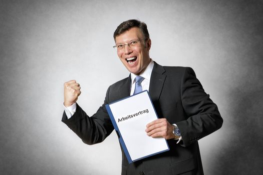 Happy business man with german employment contract