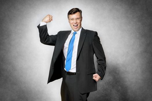 Image of happy successful business man with fist