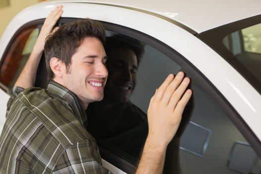 Man hugging on a car at new car showroom