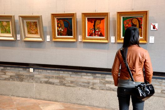 CANTON, CHINA - MARCH 8, 2011: Unidentified person admires Chinese paintings inside Chen Clan Ancestral Hall on 8th March in Guangzhou, China. 