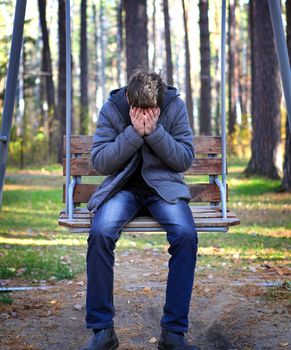 Sad Young Man in the Autumn Park