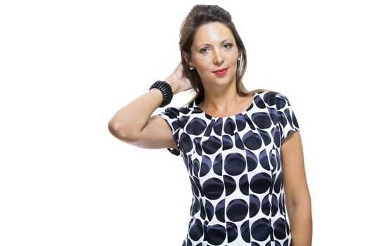 Close up Portrait of Smiling Young Lady Wearing Elegant Dress with Circle Prints, Posing with Both Hands on Waist While Looking at the Camera. Isolated on White Background.