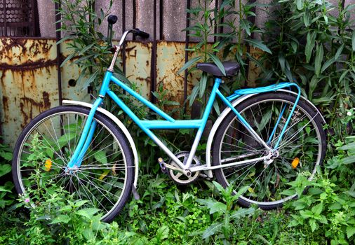 Lost Bicycle on the Old Wall in the Summer