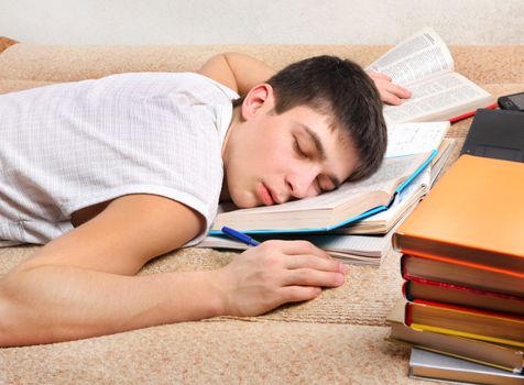 Tired Teenager sleep on the Sofa with the Books