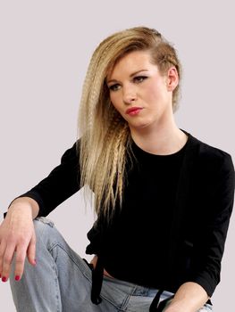 beautiful blonde woman in jeans posing, studio shot