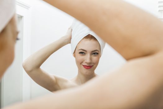 Close up Fresh Young Woman From Shower Looking her Face While Touching it In Front the Mirror