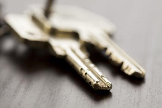 Macro Shot of Conceptual House Keys on Top of Wooden Table