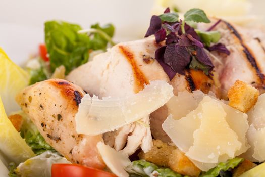 tasty fresh caesar salad with grilled chicken parmesan and croutons