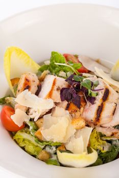 tasty fresh caesar salad with grilled chicken parmesan and croutons