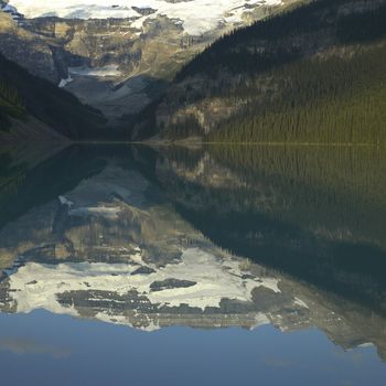 Mountains with snow reflected in a calm lake
