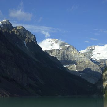 mountains with snow above a calm lake