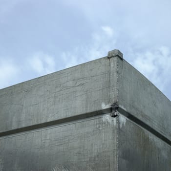 Stacks of large industrial crates against cloudy sky