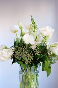 Bouquet of white and green flowers in a glass vase 