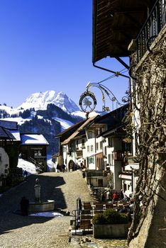 GRUYERES, SWITZERLAND - MARCH 03, 2015: View of the main street in the swiss village Gruyeres, Switzerland . The town and region are famous for their Swiss Cheese called Gruyere.
