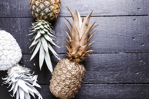 Fancy, white pineapple on the wooden table