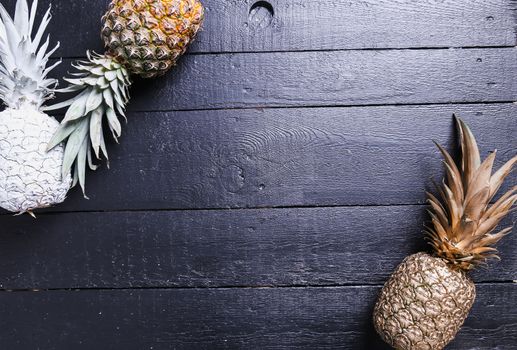 Fancy, white pineapple on the wooden table