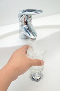 Filling glass of water from stainless steel faucet