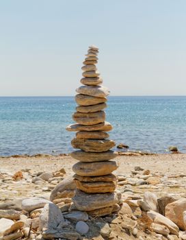 Photo of a tall stone sculpture in the beach 