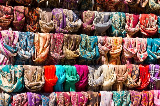 Colorful scarves (foulards) hanging in a shelf in the market