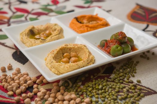 Delicious and healthy hummus set in white pate.