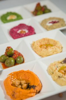 Delicious and healthy hummus set in white pate.