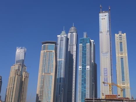 View of Sheikh Zayed Road skyscrapers in Dubai, UAE.  The Sheikh Zayed Road (E11 highway) is home to most of Dubai's skyscrapers, including the Emirates Towers.
