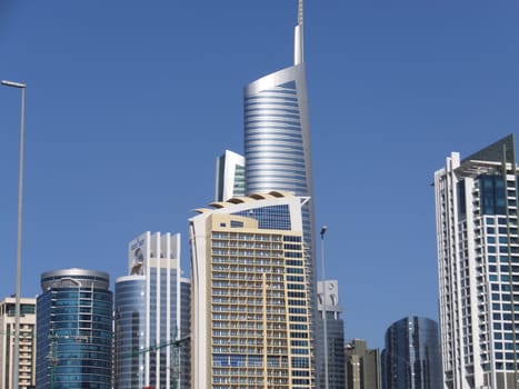 View of Sheikh Zayed Road skyscrapers in Dubai, UAE.  The Sheikh Zayed Road (E11 highway) is home to most of Dubai's skyscrapers, including the Emirates Towers.