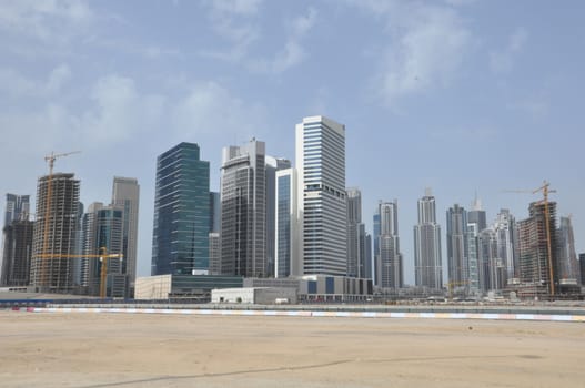 View of Sheikh Zayed Road skyscrapers in Dubai, UAE. The Sheikh Zayed Road (E11 highway) is home to most of Dubai's skyscrapers, including the Emirates Towers.
