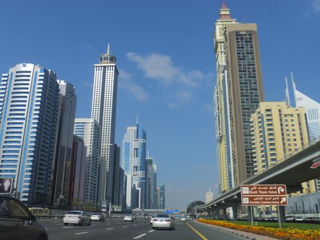 View of Sheikh Zayed Road skyscrapers in Dubai, UAE. The Sheikh Zayed Road (E11 highway) is home to most of Dubai's skyscrapers, including the Emirates Towers.