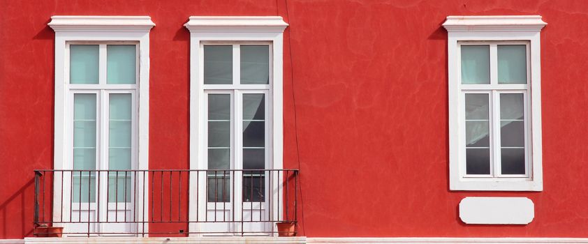 Spain. Canary Islands. Gran Canaria island. Las Palmas de Gran Canaria. Detail of ochre facade with three windows